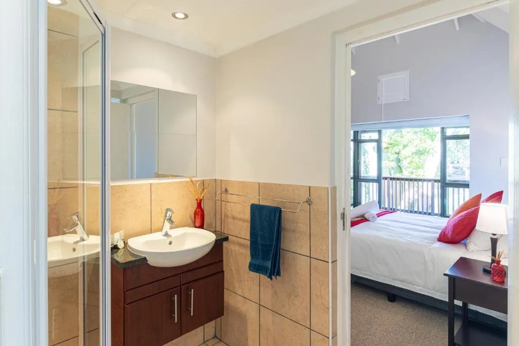 Modern bathroom with round sink, wooden vanity, and glass shower enclosure