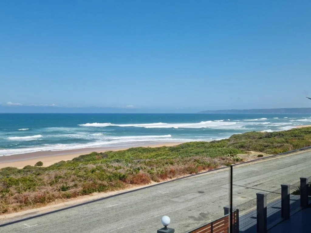 Expansive ocean view with sandy beach and rolling waves from property deck