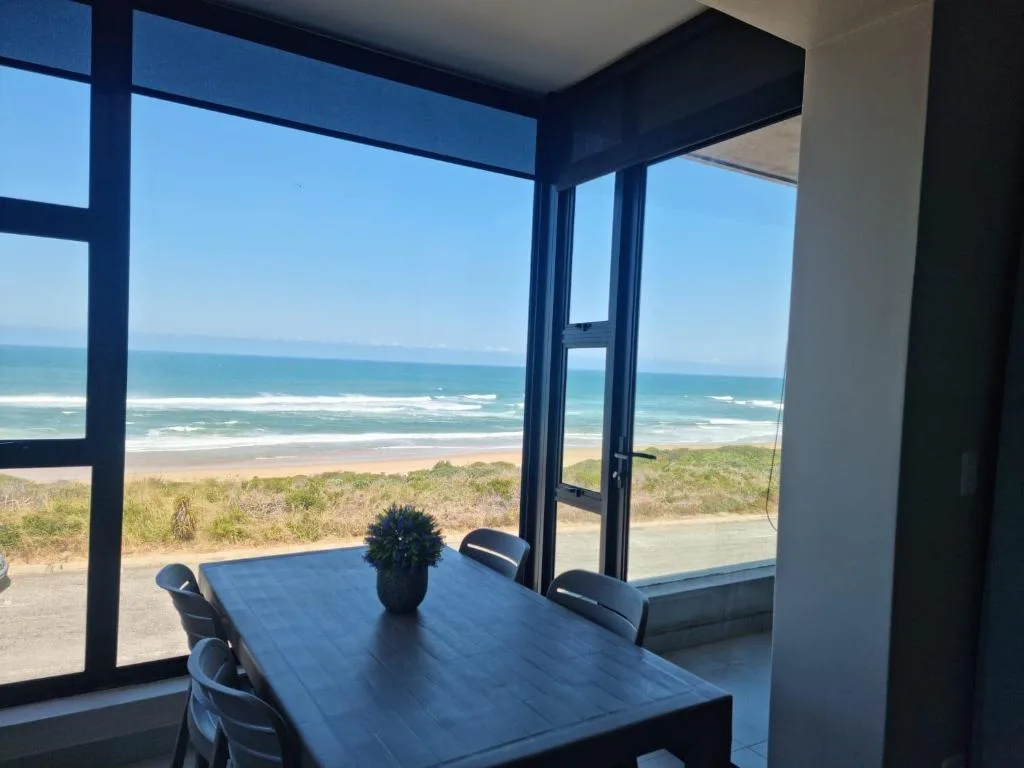 Ocean and beach vista through large windows from dining area