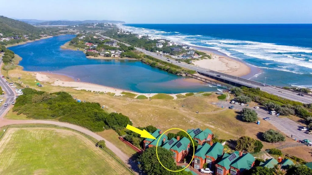 Aerial view of beachfront property overlooking lagoon and ocean