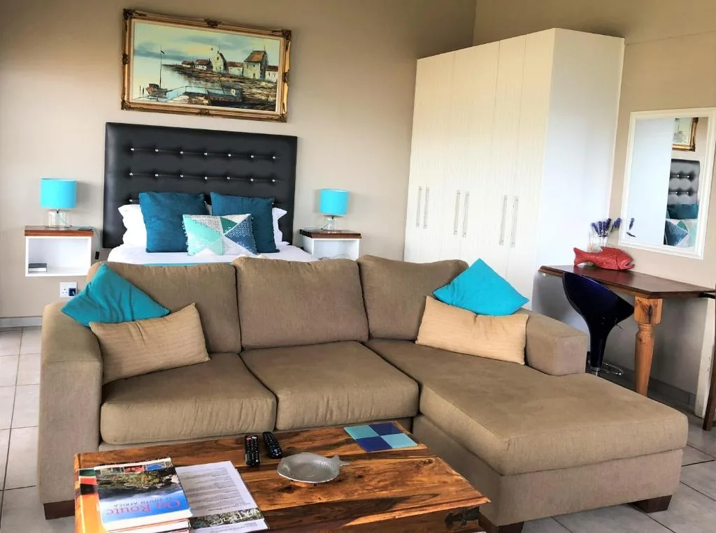 Spacious lounge with taupe sectional sofa and turquoise accent pillows